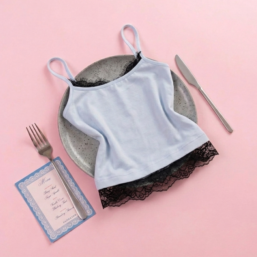 Light blue camisole with black lace trim on a pink background